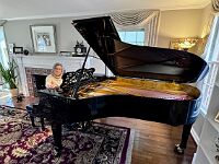 2025-02-24 Steph with Julian's New Piano 03 copy Steph continues piano lessons, sometimes at her instructor's home on his new Fazioli grand. Steve's guitars continue to multiply in his music room (our...